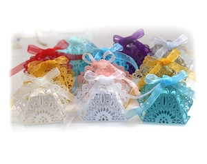 Laser-cut peacock candy boxes in assorted colors with sheer organza ribbon bows