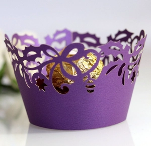 Detailed macro view of a purple laser-cut cupcake wrapper with elegant floral patterns