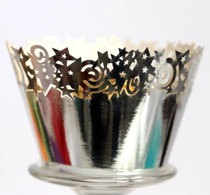 Macro view of silver laser-cut star pattern cupcake wrappers with metallic finish