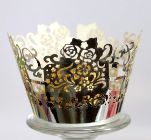 Detail of laser cut rose pattern cupcake wrapper with silver metallic finish