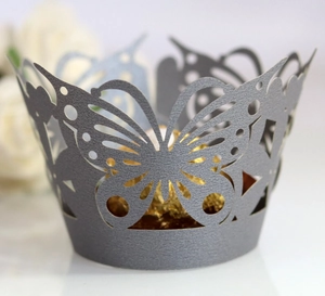 Laser-cut butterfly cupcake wrapper detail in pearlized silver with intricate hollow design