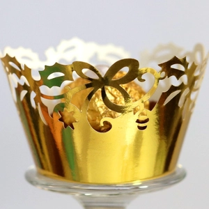 Elegant gold hollow laser-cut cupcake wrappers with bow and star patterns for party decor