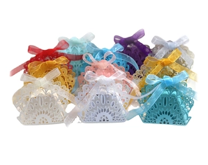 Laser-cut wedding favor boxes with peacock floral patterns and ribbon bows in multi colors
