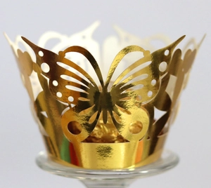 Laser-cut golden butterfly cupcake wrappers with hollow lace design for elegant dessert displays