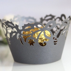 Elegant laser-cut gray cupcake wrapper with intricate holiday vine and star pattern