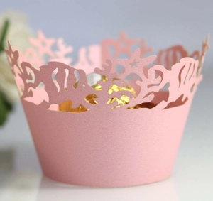 Pale pink laser-cut ocean themed cupcake liners with starfish and coral cutout patterns