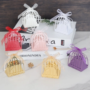 Laser cut birdcage wedding favor boxes in various colors with matching ribbons