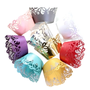 Hollow laser-cut cupcake wrappers with floral and butterfly patterns in various colors