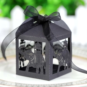 Detail of black laser-cut elephant candy box with elegant ribbon bow for party favors