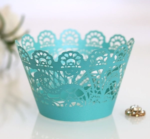 Detail showing tiffany blue laser-cut cupcake wrappers with elegant floral hollow pattern