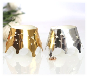 Detailed close-up of gold and silver crown cupcake liners with star cut-out design