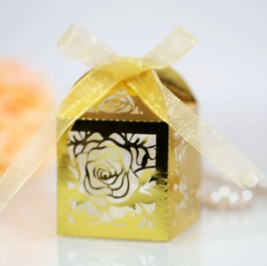 Detailed view of golden laser-cut rose gift box with elegant ribbon and floral decor