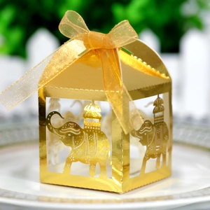 Detail of golden elephant laser-cut favor box with an elegant organza ribbon bow