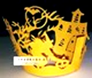 Laser-cut Halloween cupcake wrapper featuring a haunted castle, bat, and moon pattern