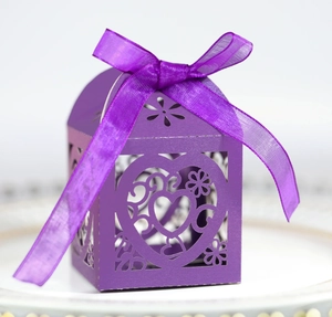 Laser cut purple wedding candy box with heart patterns and silk ribbon bow