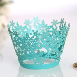 Lace snowflake cupcake wrappers in tiffany blue with intricate laser cut hollow patterns