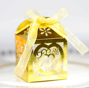 Golden laser-cut heart favor box with yellow ribbon bow for weddings and gifts