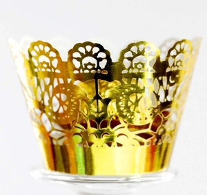 Elegant gold laser-cut lace cupcake wrappers with intricate floral patterns for weddings