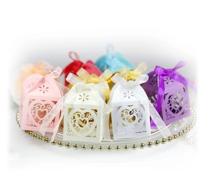 Macro detail of laser-cut heart pattern gift boxes with elegant organza ribbons