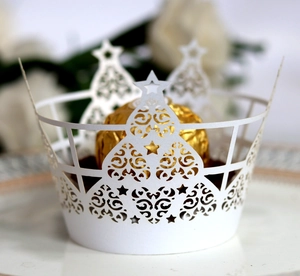 Laser-cut white paper cupcake liner with Christmas tree and star patterns for party decor