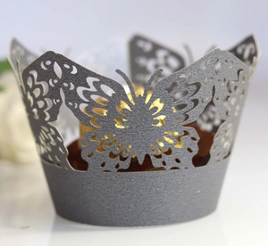 Macro detail of laser-cut butterfly cupcake wrapper in dark grey pearlescent finish