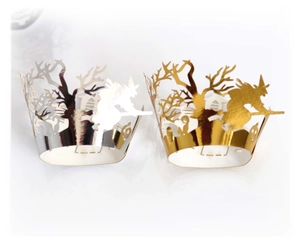 Laser-cut Halloween cupcake liners with gold and silver silhouettes of witches and trees