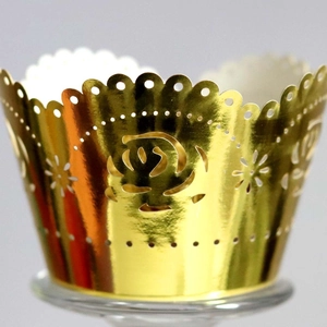 Golden mirror finish cupcake wrapper with laser-cut hollow rose pattern and wavy edges