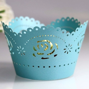 Laser cut light blue cupcake wrapper with rose patterns and scalloped wave edges