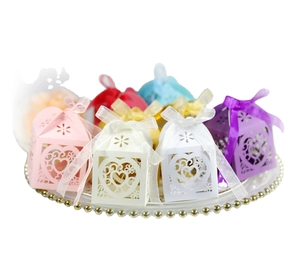 Laser-cut heart-shaped candy boxes in multiple colors with silk ribbon bows for weddings