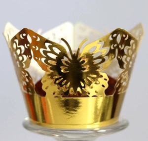 Elegant gold laser-cut butterfly cupcake wrappers with metallic finish for party decoration