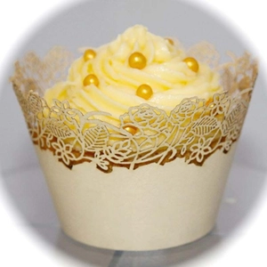 Detailed laser-cut cupcake wrapper featuring intricate cream rose patterns for weddings