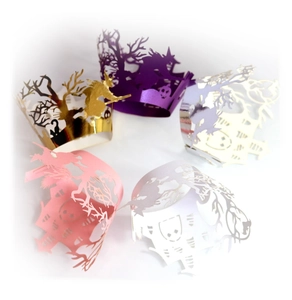 Laser-cut Halloween cupcake wrappers with witch and pumpkin designs in pearl finishes