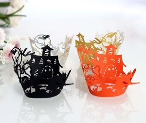 Detail of laser-cut Halloween cupcake wrappers with castle and bat hollow patterns