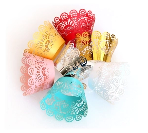 Detailed view of laser-cut lace cupcake wrappers in various metallic colors