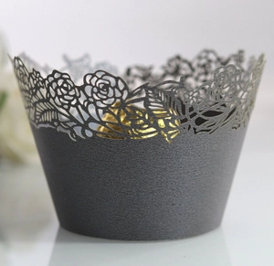 Detailed view of dark green hollow rose laser cut cupcake wrapper with elegant matte texture