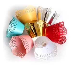 Lace hollow cupcake wrappers in silver and gold with intricate floral vine laser cut patterns