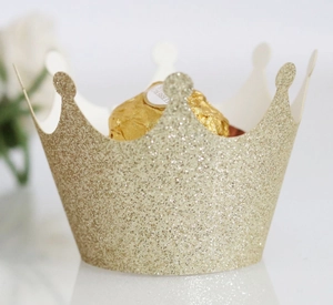 Close-up of champagne gold glitter crown cupcake wrapper with chocolate inside