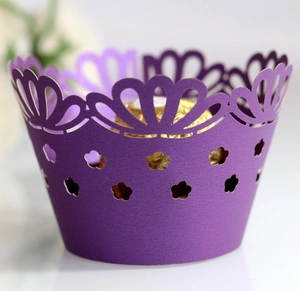 Purple laser-cut paper cupcake wrappers with crown edge and gold foil insert