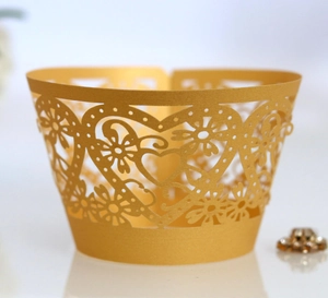 Detailed laser-cut heart and floral pattern on golden pearlescent cupcake wrappers