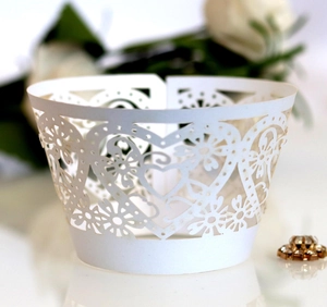 Detailed laser-cut heart flower pattern on white wedding cupcake wrappers