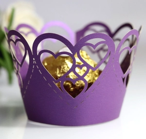 Detailed laser-cut dark purple cupcake wrapper with heart patterns for party decorations