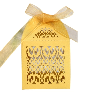 Laser cut hollow wedding favor box in golden yellow with ribbon bow for small gifts