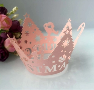 Pink Christmas cupcake wrapper detail with laser-cut snowflake and tree designs