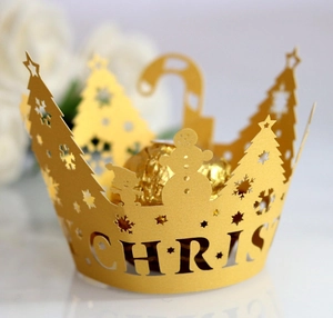 Golden laser-cut Christmas cupcake wrappers with festive reindeer and snowflake patterns