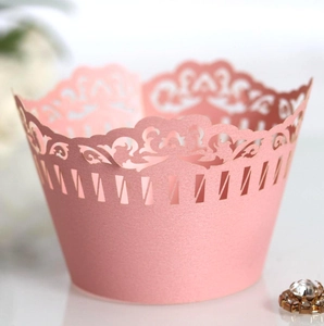 Pink laser-cut pearl paper cupcake wrappers with elegant lace pattern for weddings