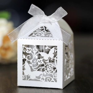 White laser cut wedding candy box featuring butterfly patterns and a ribbon bow