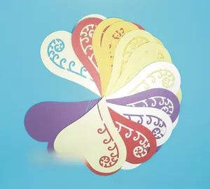 Macro detail of laser-cut heart hollow wine glass cards in various vibrant colors