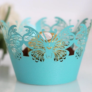 Teal laser-cut butterfly cupcake wrapper with intricate floral patterns for weddings