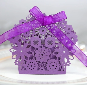Detail of purple laser-cut gift box with floral patterns and a matching organza ribbon bow