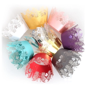 Laser cut hollow butterfly cupcake wrappers in various pearlescent colors for wedding decor
